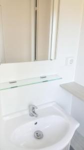 a white bathroom sink with a mirror above it at Bungalow with Shared Pool in Pataias + 30 m² + Pool. in Pataias