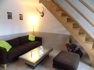 a living room with a couch and a table at Les Mathes La Palmyre - MAISON MITOYENNE en PIERRES - avec PISCINE PRIVEE in Les Mathes