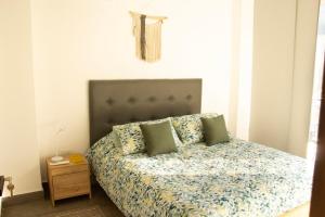 a bedroom with a bed and a night stand at Norte Cali - Bosque Living- 301 in Cali