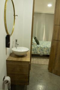 a bathroom with a sink and a mirror and a bed at Norte Cali - Bosque Living- 301 in Cali