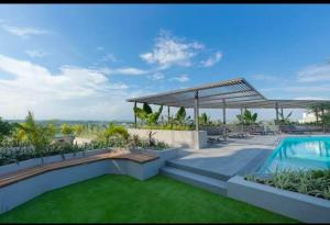 a house with a swimming pool and a lawn at Loxwood by Tripview Apartments in Accra