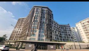 a tall building with people standing in front of it at Loxwood by Tripview Apartments in Accra