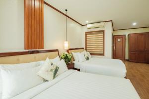 Ένα ή περισσότερα κρεβάτια σε δωμάτιο στο Sunset Westlake Hanoi Hotel