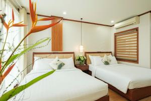 Ένα ή περισσότερα κρεβάτια σε δωμάτιο στο Sunset Westlake Hanoi Hotel
