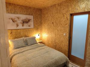 a bedroom with a large bed and a window at Casa do Bento - Rustic Cozy Loft, Vila do Conde in Fajozes