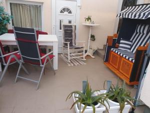 a balcony with chairs and tables and a table at Haus Nadine in Lübeck