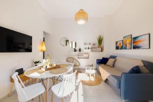 a living room with a couch and a table at Elartis Apartment in Chania Town +18 photos
