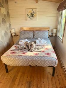 a bed in a room with two ropes on it at Ivy Rose Cabin No Hot Tub in Bude