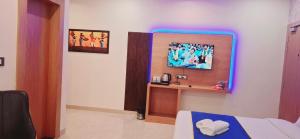 a bedroom with a bed with a blue light at BlueNeck Ayodhya-Near ShriRam Mandir in Ayodhya