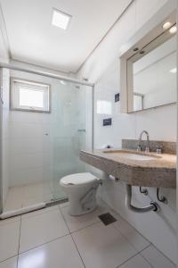 a bathroom with a toilet and a sink and a shower at Hotel Erechim in Porto Alegre