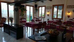 a restaurant with tables and chairs with purple table cloth at Locanda Primo Sole in Oneto