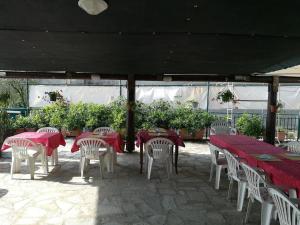 a group of tables and chairs with red table cloths at Locanda Primo Sole in Oneto