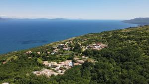 an aerial view of a house on a hill by the water at Villa Castelina Part II of twin house in Vicani