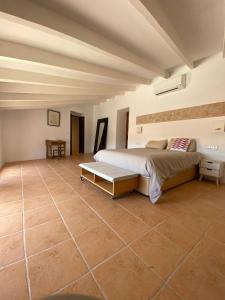 a bedroom with a bed and a tiled floor at Villas2meet Jimmy Lloret in Lloret de Vistalegre