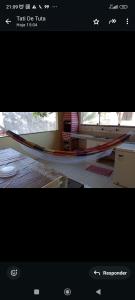 a picture of a hammock in a room at Casa Guaibim ótima localização in Valença