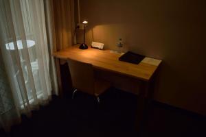 a desk in a room with a lamp on it at Motel 98 in Rockhampton