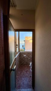 a door to a room with a dog standing in the doorway at FronteMare12 in Palermo +2 photos