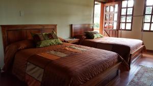 Postel nebo postele na pokoji v ubytování Hosteria San Carlos Tababela