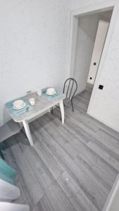 a table and a chair in a living room at Marinad 1-ком Квартира в Центре города in Petropavlovsk
