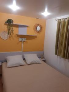 a bedroom with a bed with two white pillows at Mobile home climatisé au Lac de Lougratte in Lougratte