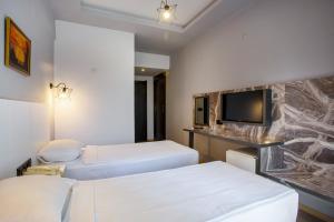 Postel nebo postele na pokoji v ubytování Aslan Sand & City Hotel