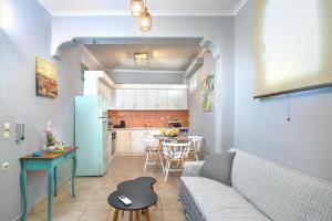 a living room and kitchen with a couch and a table at Manesko house in Gaios