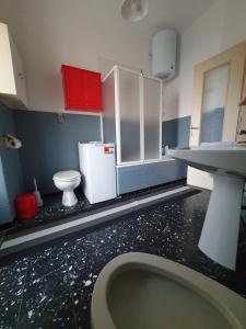 a small bathroom with a sink and a toilet at B&B del centro in Pinerolo +21 photos