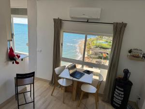 a room with a table with a laptop on it at The View Calahonda Primera Línea de Playa y Vistas Panorámicas in Mijas Costa