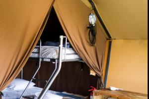 a room with two bunk beds in a tent at Camping Onlycamp de Boucocers in Lagrasse +15 photos