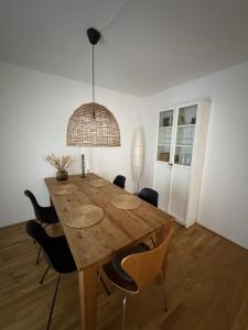 a dining room table with chairs and a light fixture at Wiembachallee in Leverkusen +20 photos