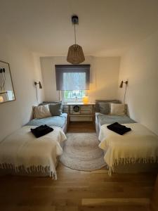 a living room with two beds and a window at Wiembachallee in Leverkusen