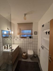 a bathroom with a tub and a sink and a toilet at Wiembachallee in Leverkusen