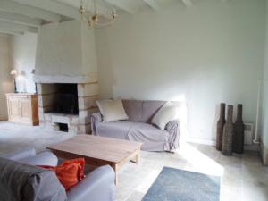 a living room with a couch and a coffee table at Domaine de Monciaux 2 piscines Tennis 40 Pers in Bourrou