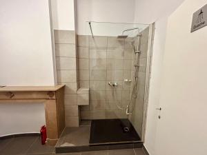 a shower with a glass door in a bathroom at European District Hostel in Brussels +52 photos