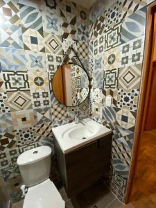a bathroom with a toilet and a sink and a mirror at Villa Nikitina in Los Santos +38 photos