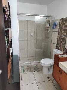 a bathroom with a shower and a toilet at Casa en condominio de playa para 12 personas, Asia in Rosario de Asia