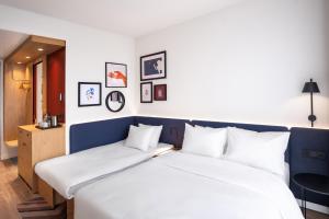 Postel nebo postele na pokoji v ubytování Hampton By Hilton Tallinn
