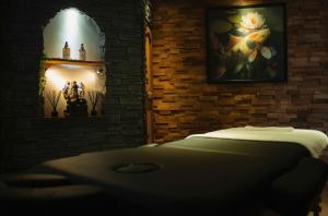 a bedroom with a bed in a brick wall at Villa-Aphrodia love room in Thionville +12 photos