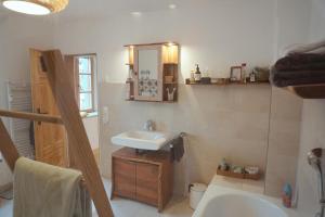 a bathroom with a sink and a bath tub at Alpen Lounge Leitzachtal - große urige Wohnung mit Dachterasse und Bergblick in Fischbachau +41 photos