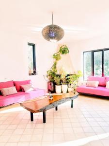 - un salon avec des canapés roses et une table basse dans l'établissement RELAXING EXPERIENCE In ESSAOUIRA-VILLA OLIVE, à Essaouira