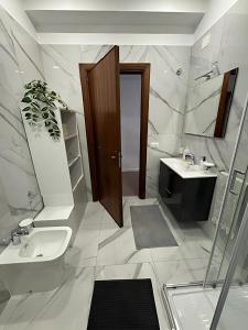 a bathroom with a sink and a mirror at Rest Guesthouse 2,0 in Melito di Porto Salvo +13 photos