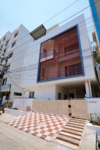 a building with a checkered floor in front of it at Golden villa A luxury HomeStay - Near To Bhudevi Complex TTD Ticket Counter Alipiri in Tirupati