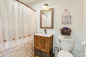 a bathroom with a toilet and a sink and a mirror at Riverfront Home with Private Dock in Wisconsin Dells in Lyndon Station +24 photos