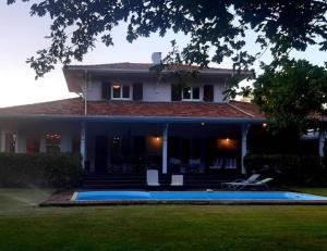 a house with a swimming pool in front of it at Villa Romance in Audenge