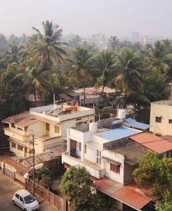 an aerial view of a city with houses and palm trees at Be My Guest Homestay WHISPERING WIND in Kolhapur
