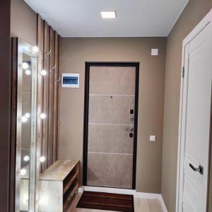 a bathroom with a shower and a glass door at comfort apartment in Karagandy