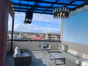 a balcony with chairs and a view of a city at T-Roys Apartments in Accra