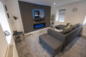 a living room with a couch and a tv at No 4 John Street in Bethesda