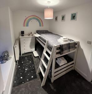 a bedroom with a bunk bed with a desk and a rainbow at No 4 John Street in Bethesda
