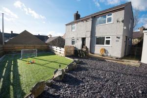 a yard with a soccer field in front of a house at No 4 John Street in Bethesda